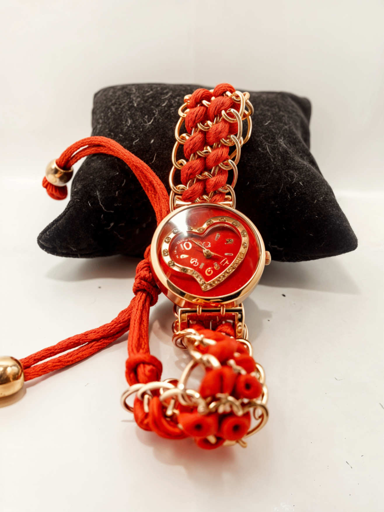 red ribbon watch on black pillow