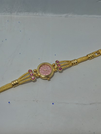 gold color watch for girls on white surface